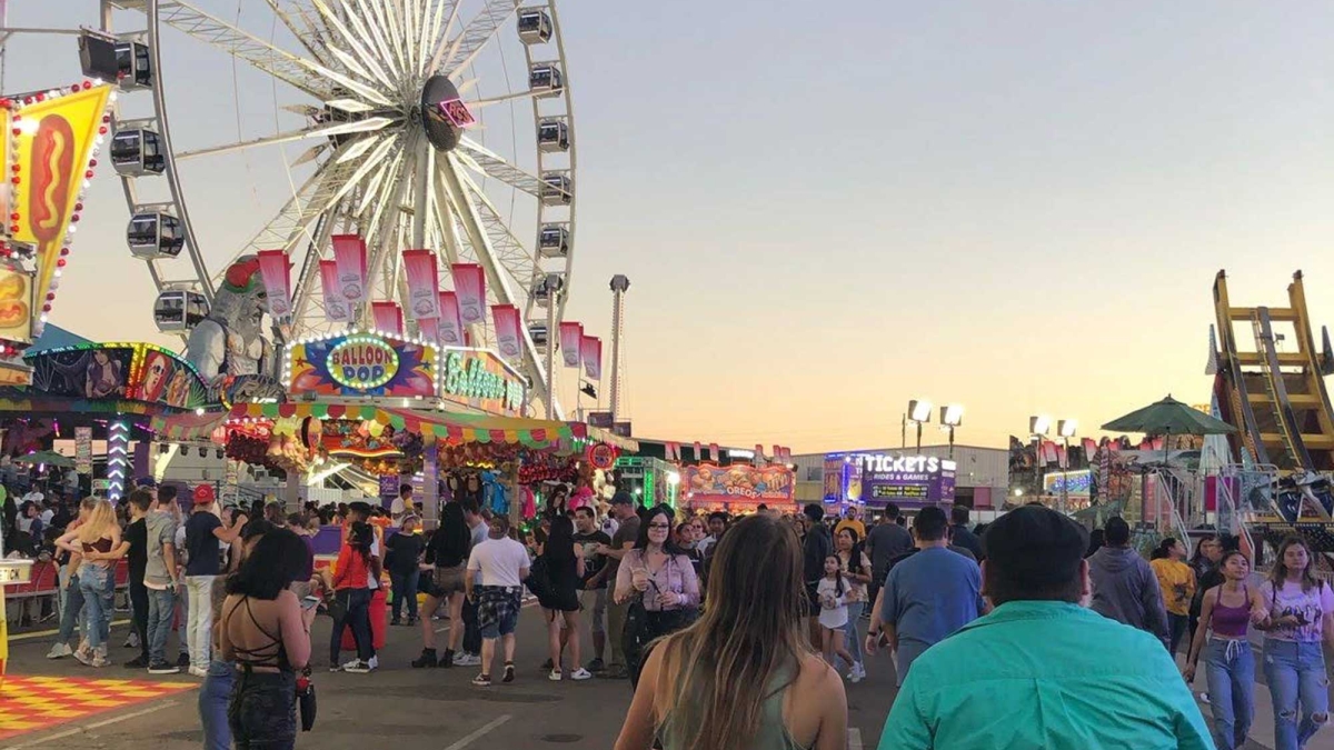 People walk the midway at the Arizona State Fair