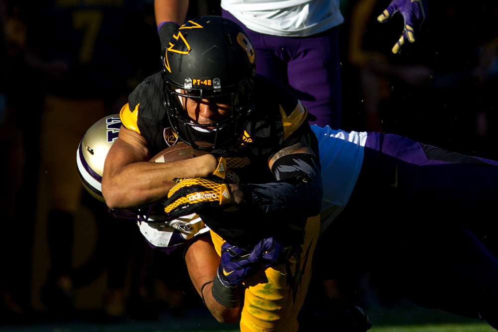 Wide receiver D.J. Foster pushes for extra yardage against the Washington defense.