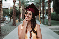 woman posing in grad cap on Palm Walk
