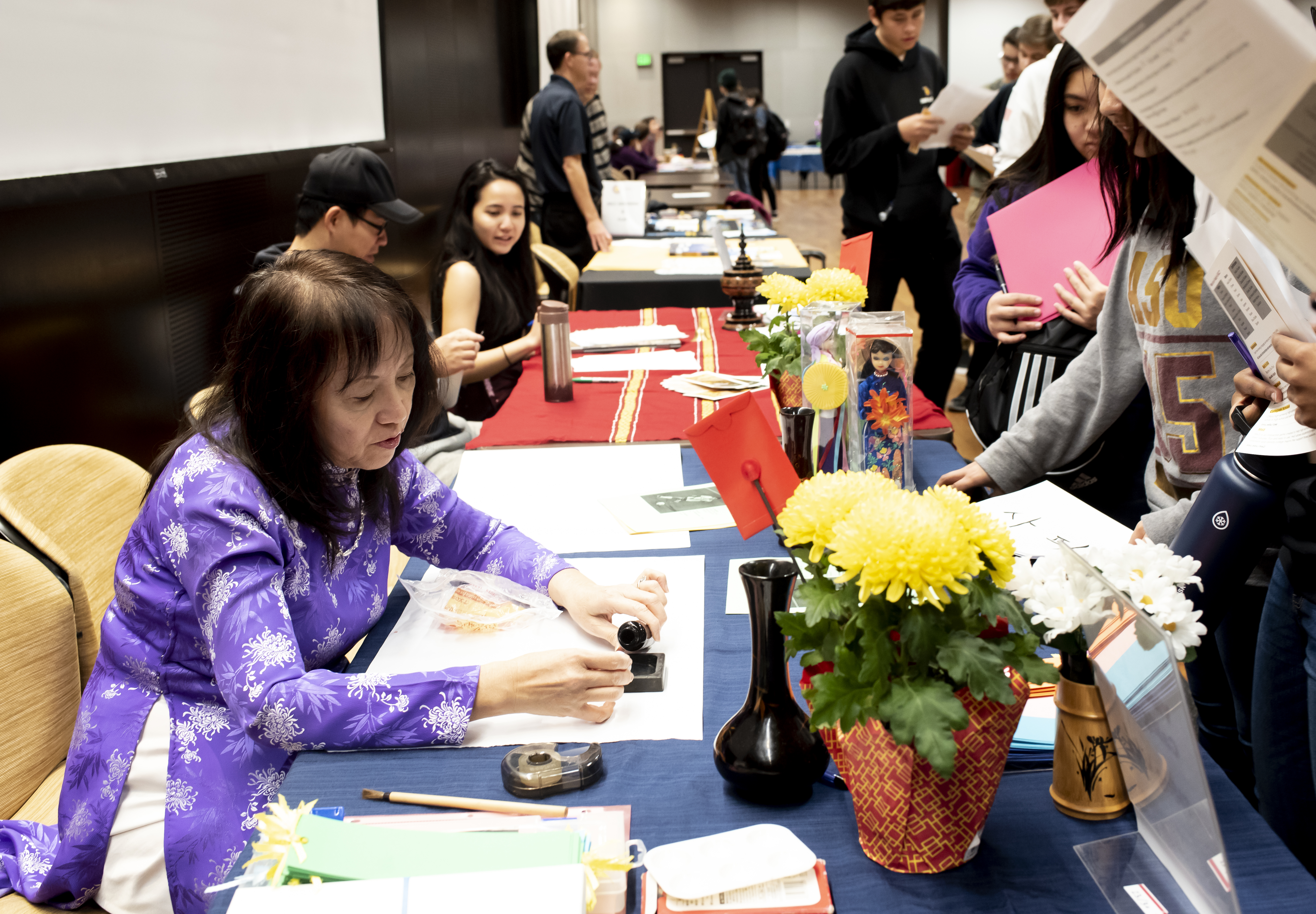 ASU Vietnamese language lecturer Thuy-Kim Le writes names in Vietnamese ink calligraphy for visiting students.