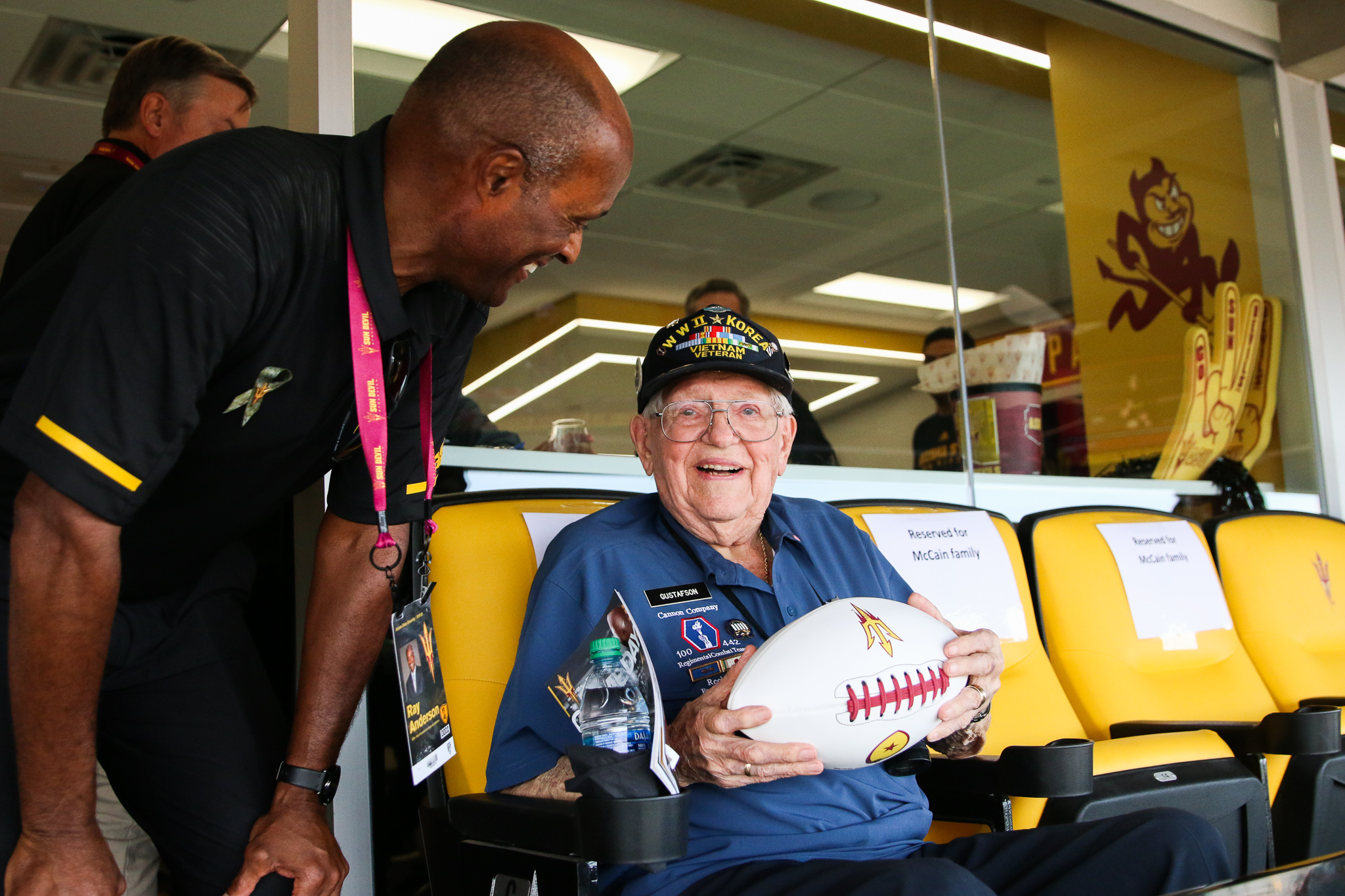ASU alumnus and veteran Jerry Gustafson is presented with an autographed Herm Edwards football during Salute to Service 