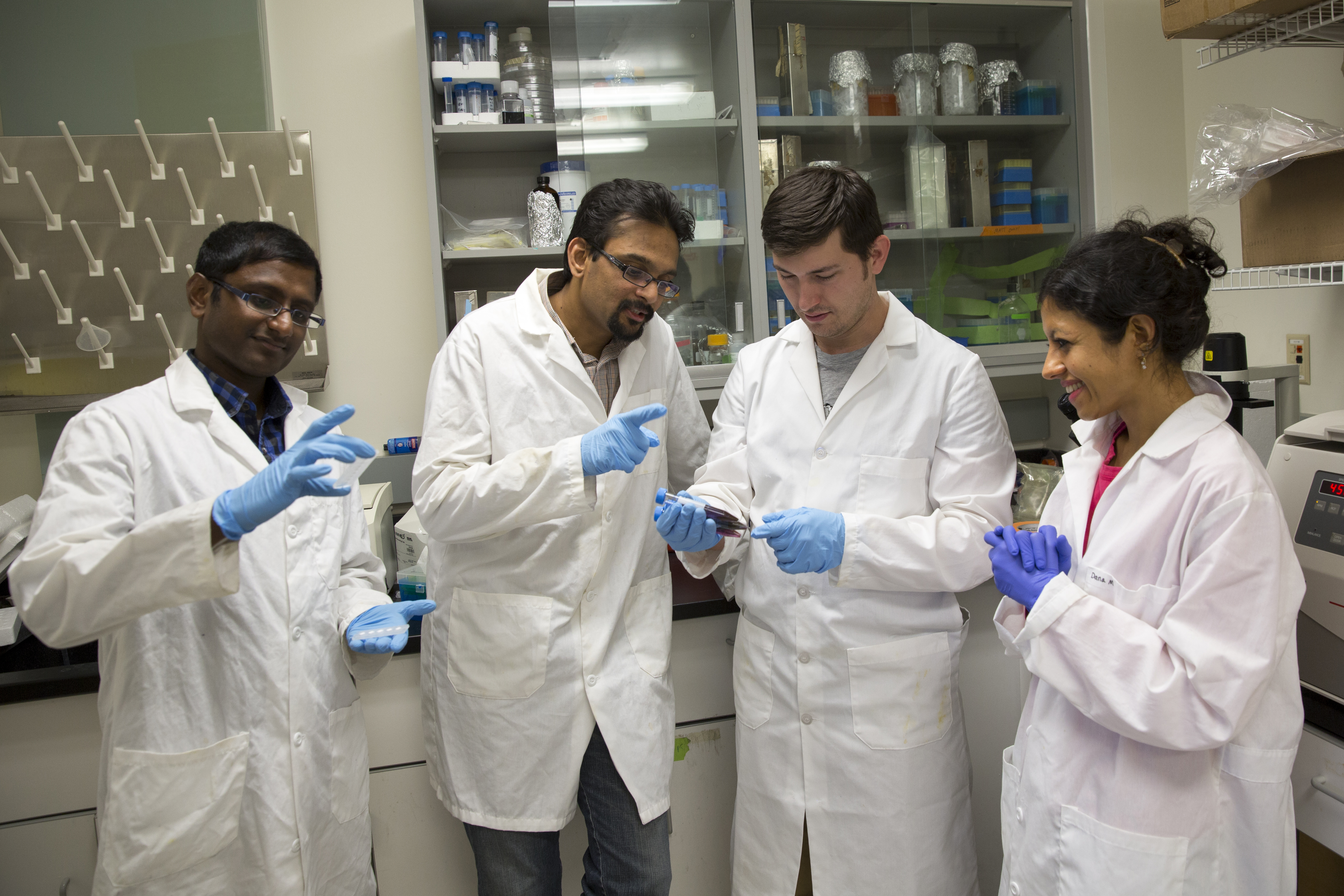 four people working in lab