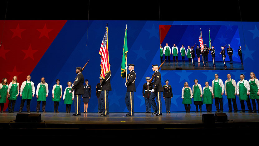 Starbucks choir and military members onstage