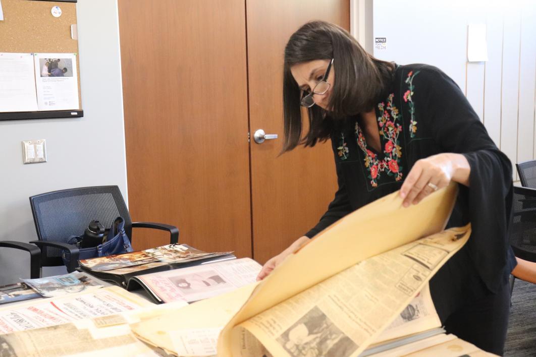 Kristine Navarro looks through historic materials
