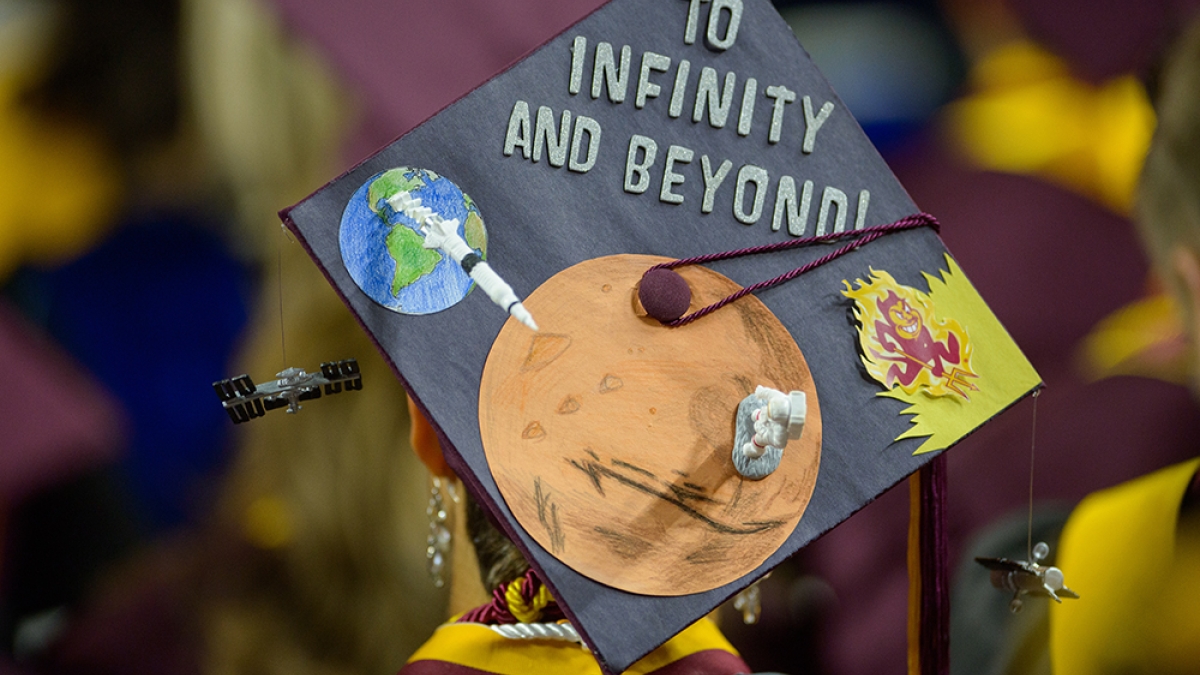 graduation cap that says "To infinity and beyond"