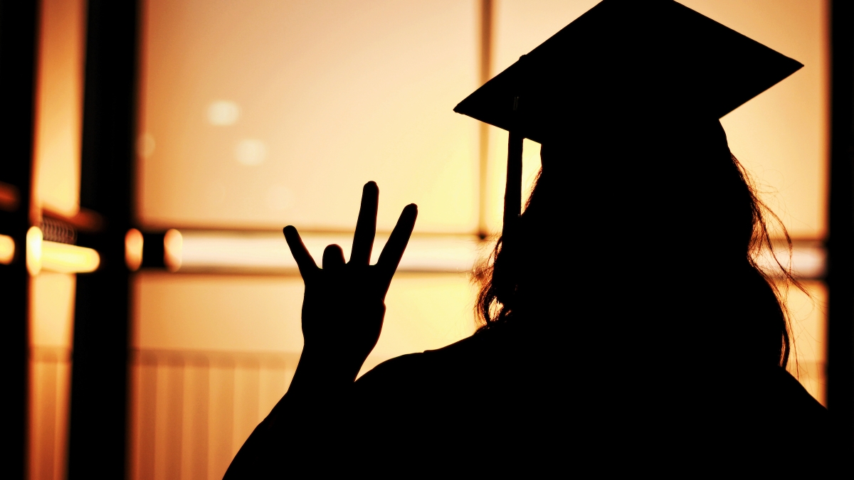 Silhouette of a grad with cap and gown