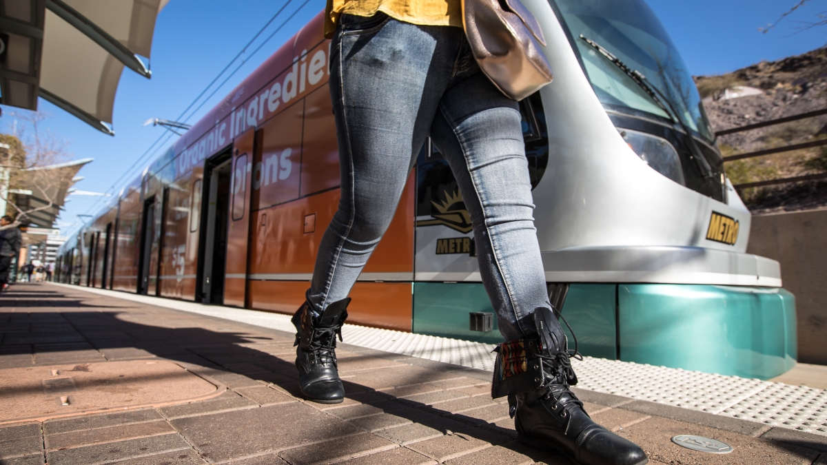 woman walking on light rail platform