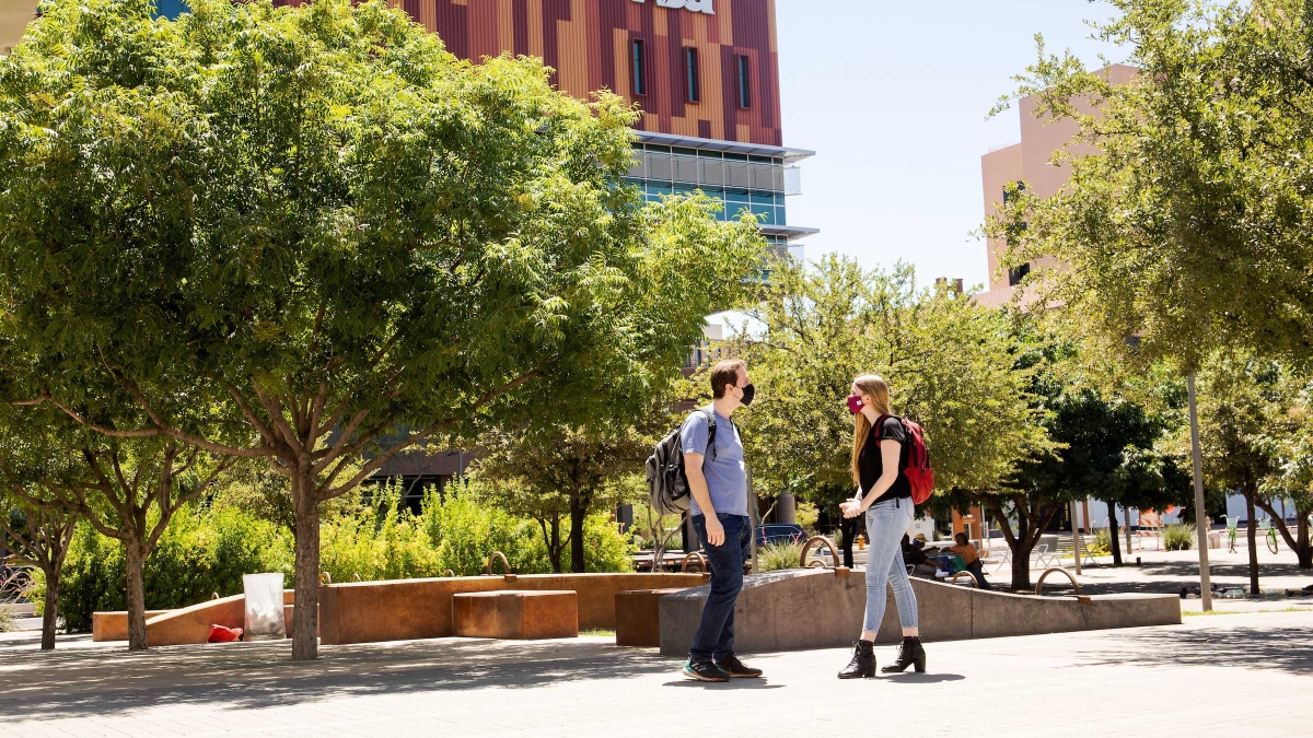 Students walk on a sidewalk on the downtown campus