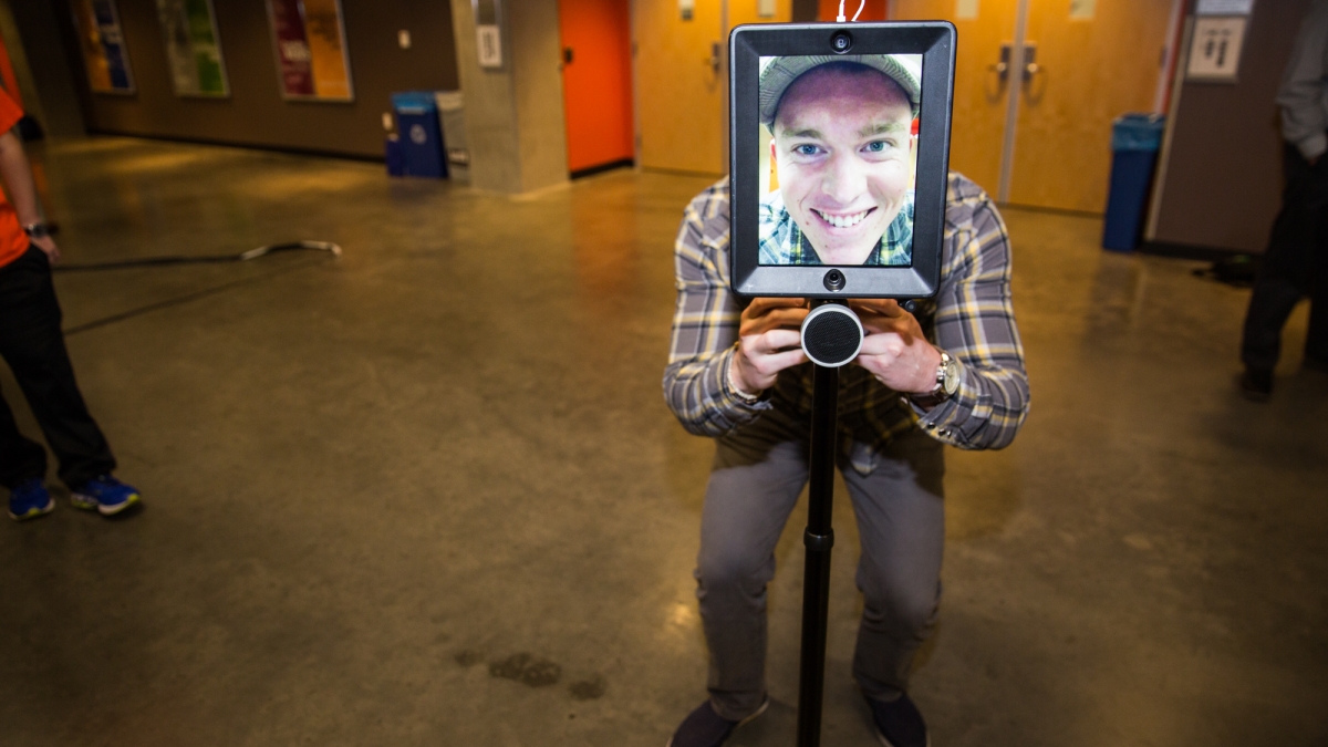 A student uses an iPad camera apparatus at Innovation Day.