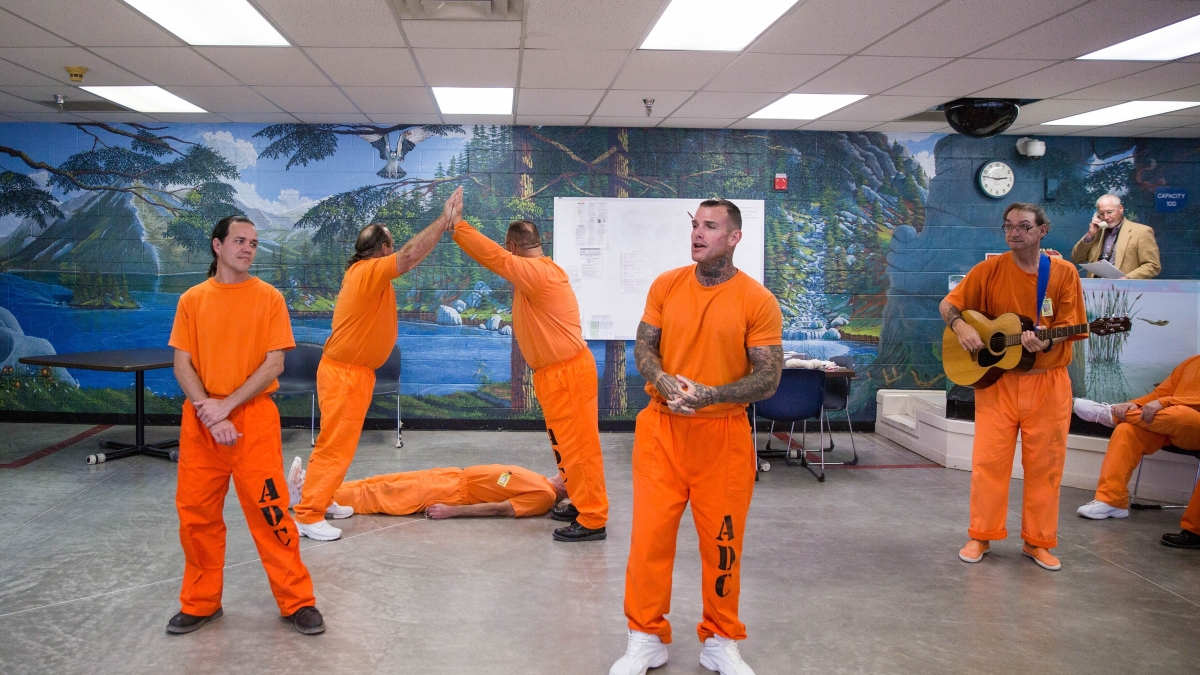 Inmates act in a prison theater program.