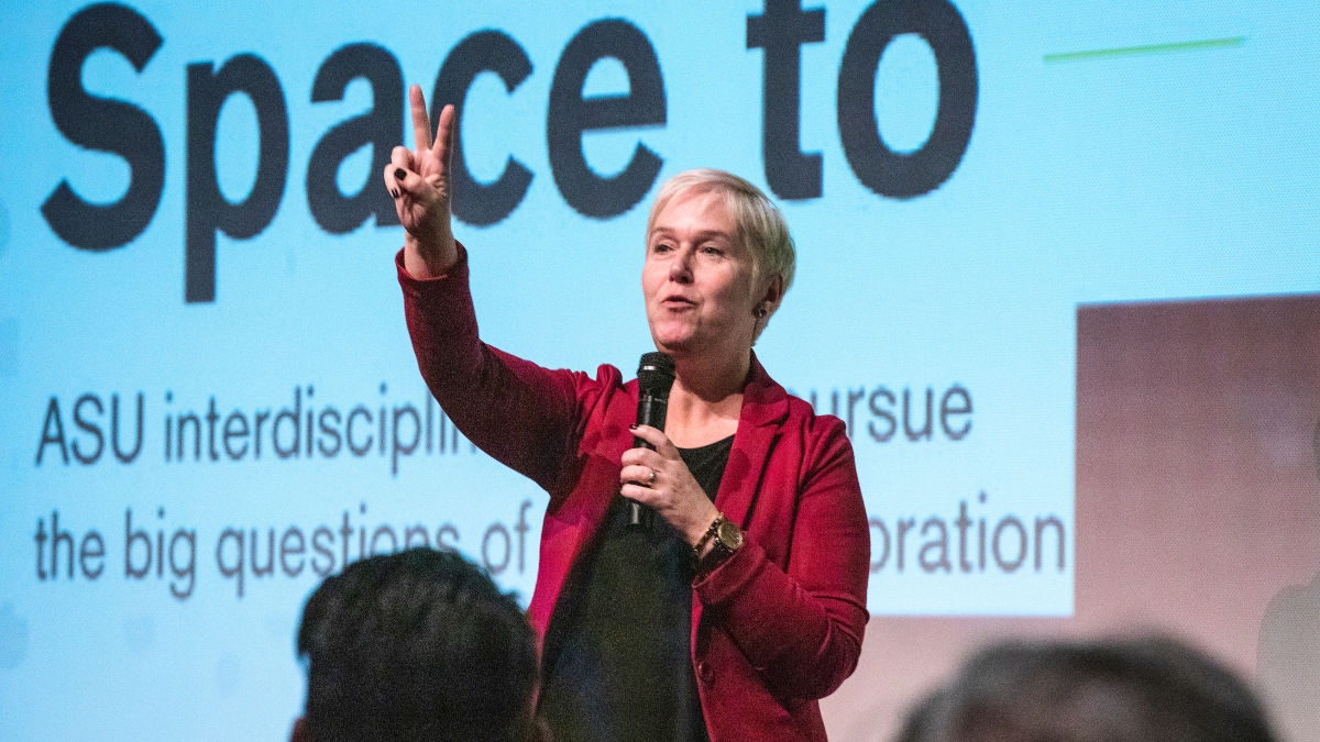 Lindy Elkins-Tanton speaks in front of a projector screen at an ASU Space to Thrive space missions panel
