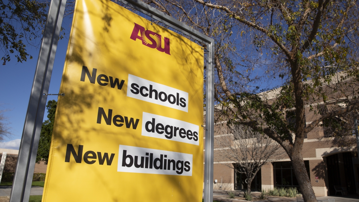 Outdoor ASU sign reading "New schools New degrees New buildings" in front of a building.