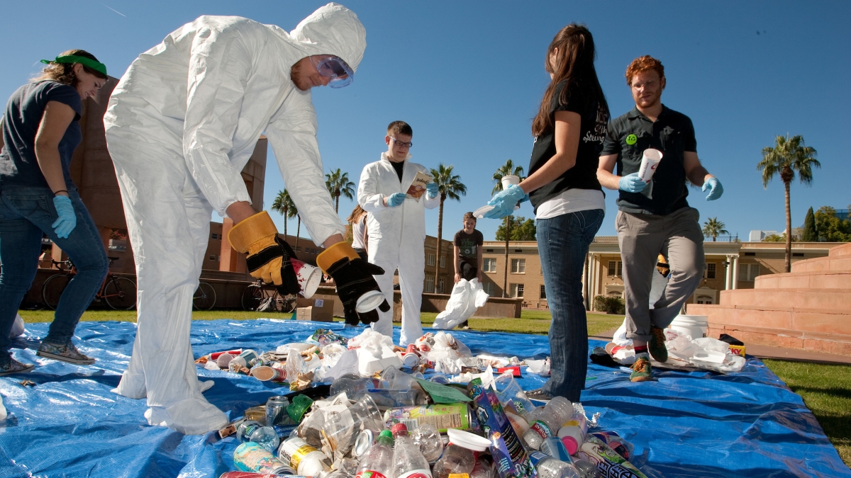 People sorting through waste for recyclables