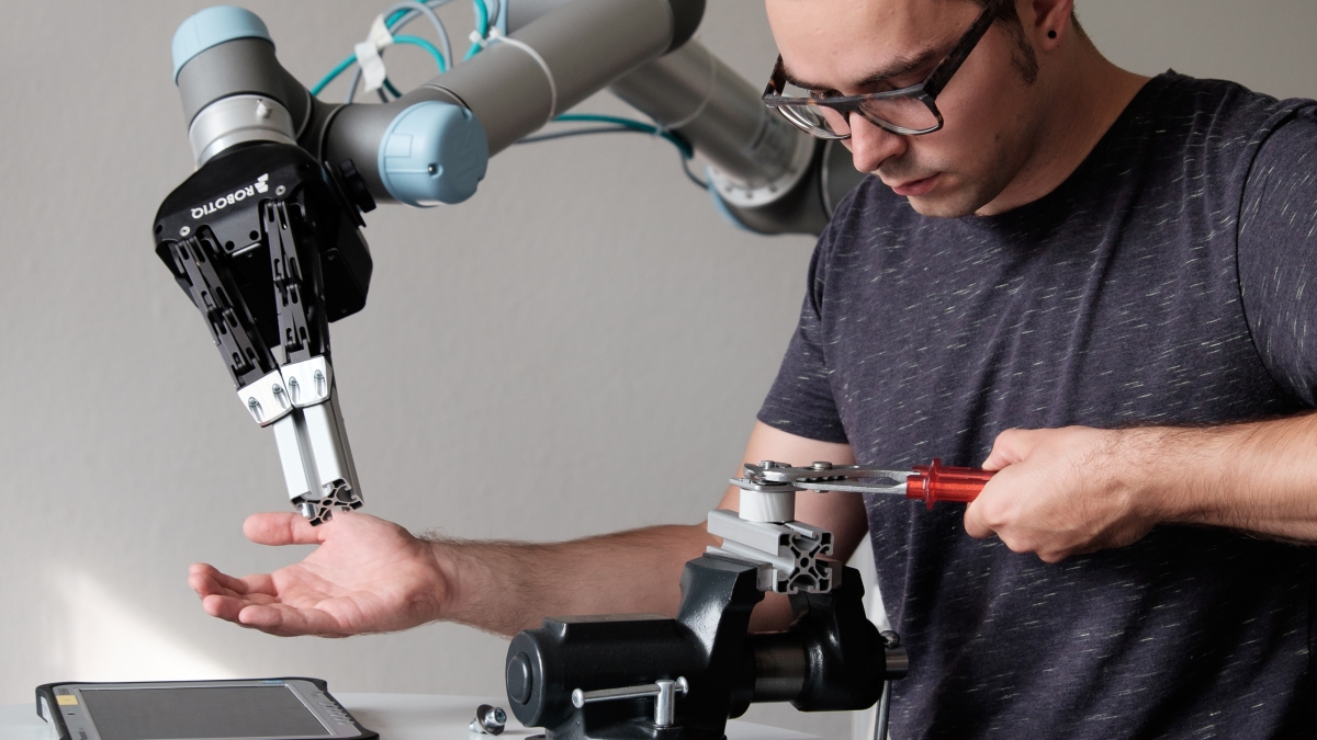 man working with robot arm