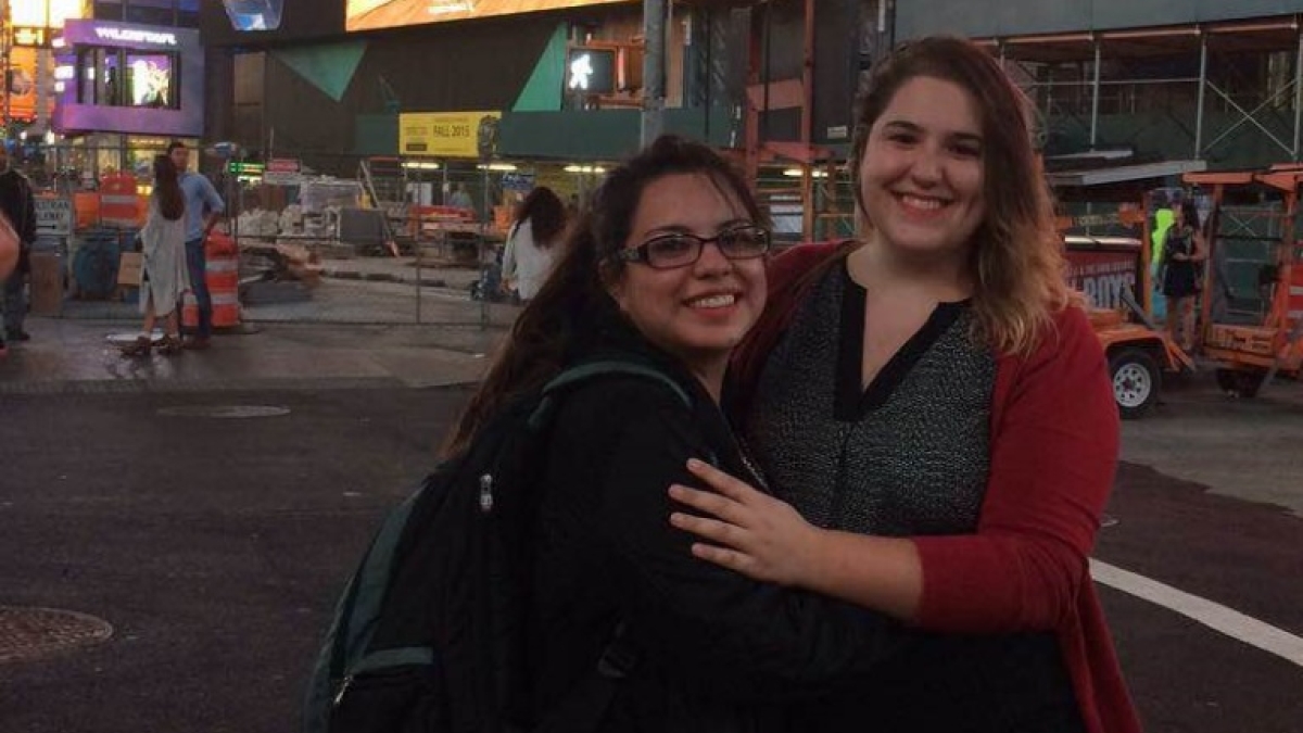 two girls pose in Times Square