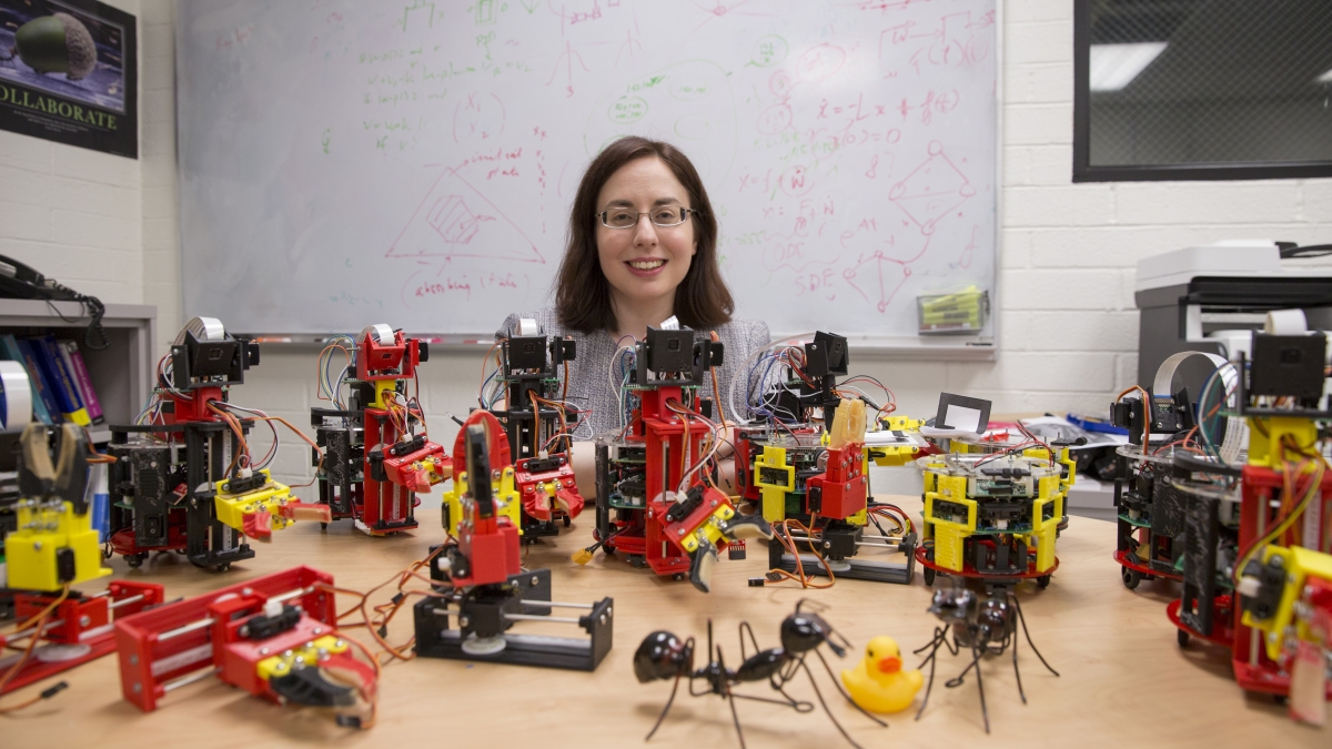 ASU engineer posing with bio-inspired robots