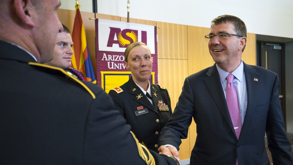 Secretary of Defense shaking hands with members of the military