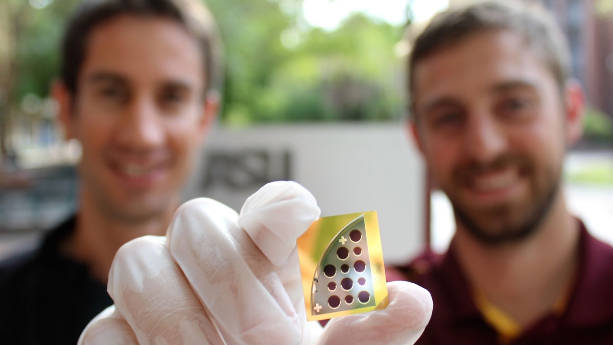 Mathieu Boccard (left) and Jacob Becker (right) pose with a 20 percent CdTe solar cell developed in tandem by Yong-Hang Zhang's and Zachary Holman's laboratories
