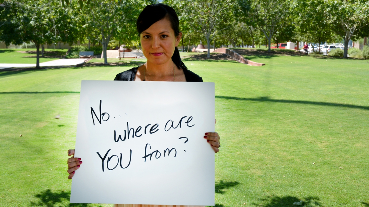 woman holding a sign displaying a "microaggression"
