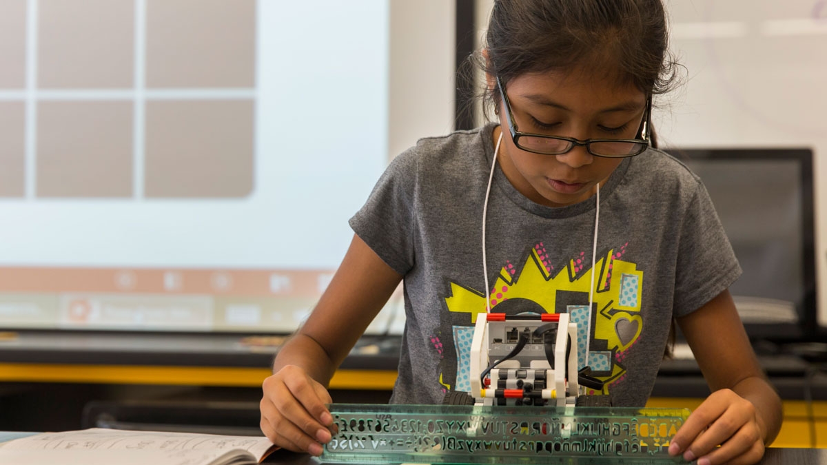 A student tests her LEGO robot at the FIRST LEGO League summer camp.