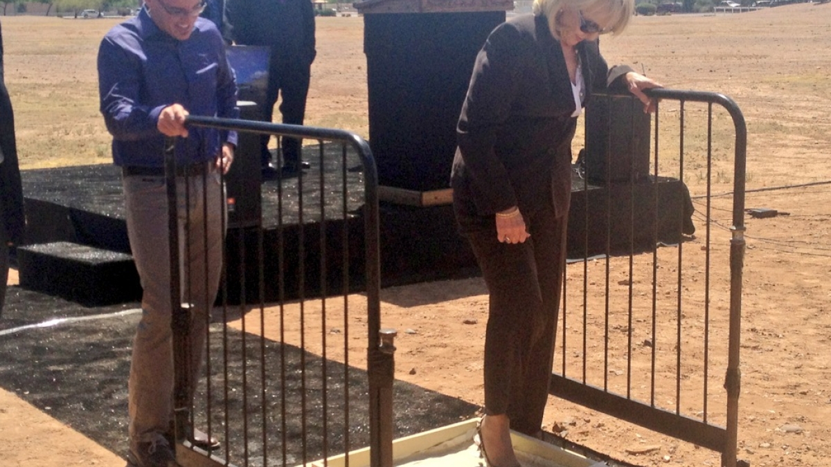 AZ Governor Jan Brewer steps in cement as GoDaddy CEO Blake Irving looks on. 