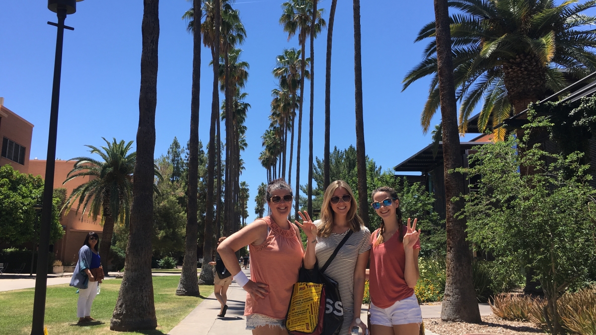 three women flashing pitchfork on Palm Walk