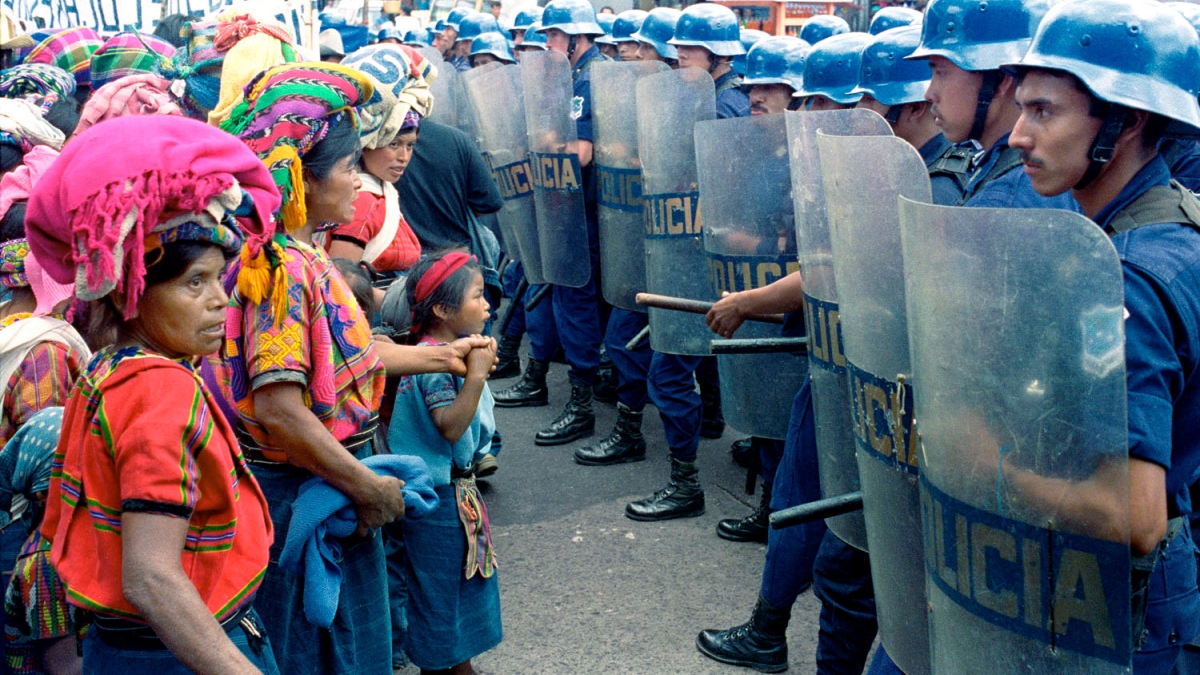 protestors facing line of police in Latin America