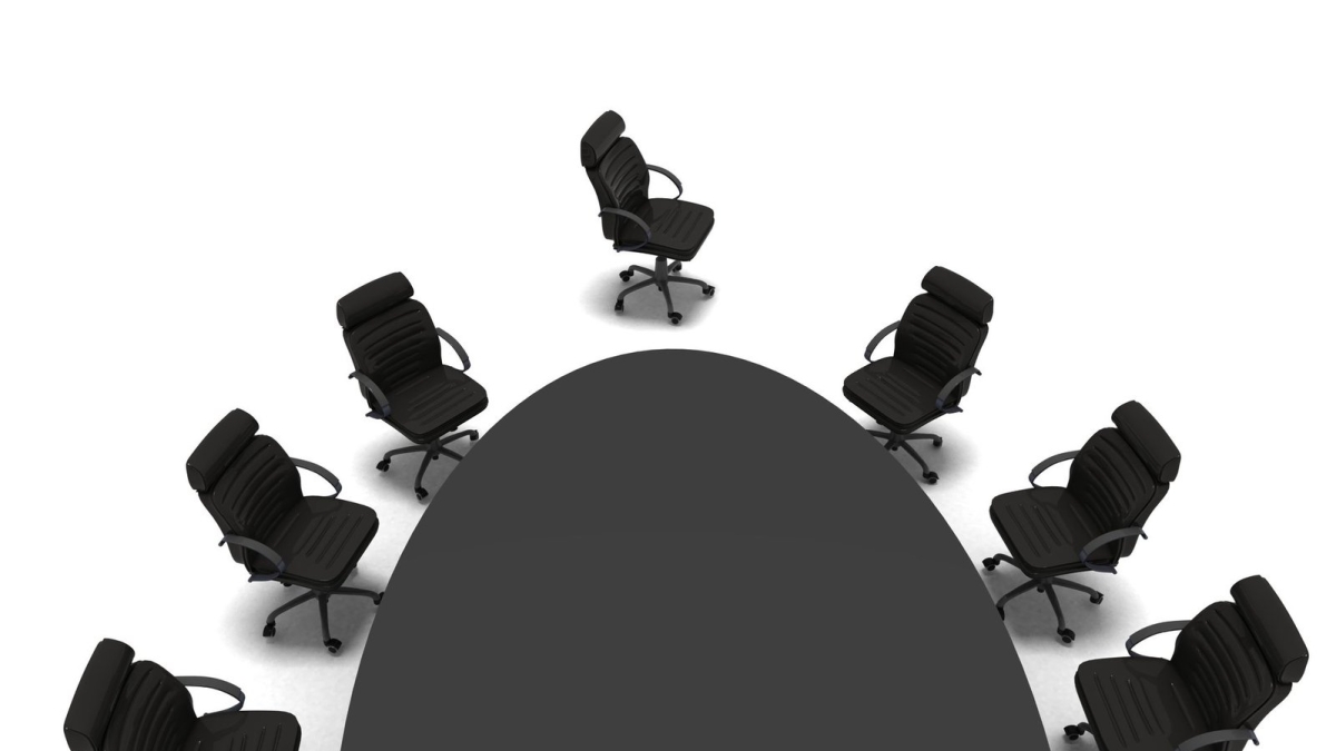 Chairs around the edge of a conference table
