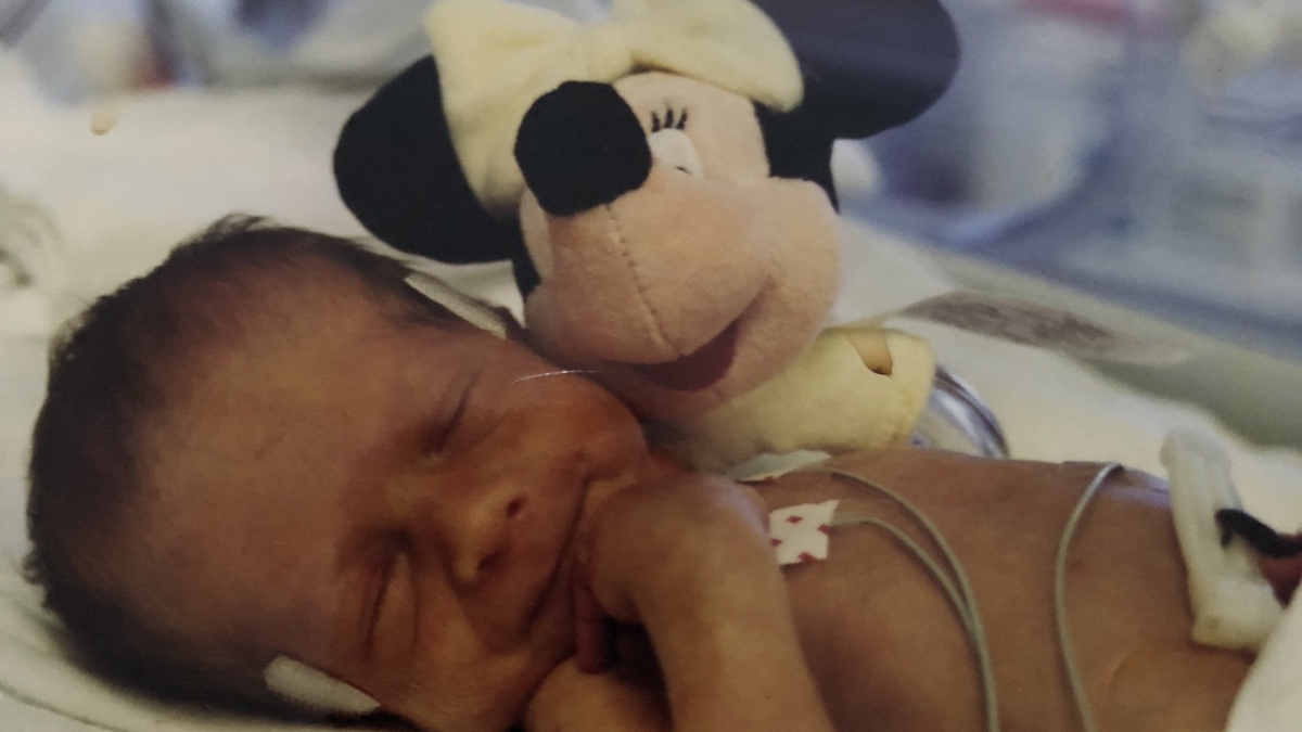 Baby Taylor Zimelman next to a stuffed animal