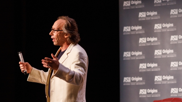 Lawrence Krauss speaking on stage during Origins event