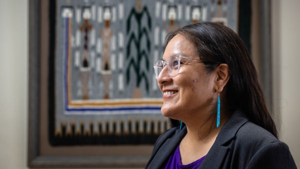 Woman's portrait in front of Navajo rug