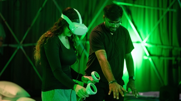 Students interacting in an immersive virtual reality installation.