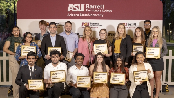 2024 Gold Standard Award winners posing with certificate awards in front of a ASU Barrett-branded sign