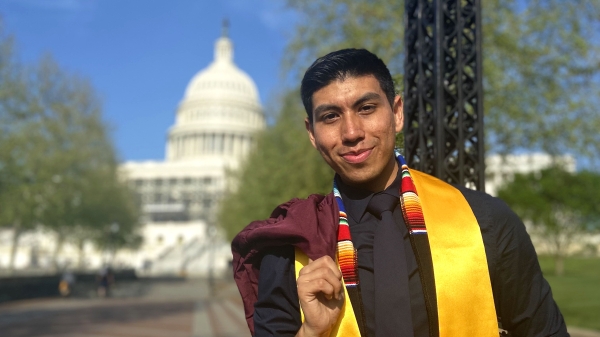 ASU grad Alexis Rodriguez standing in front of the U.S. Capitol Building wearing graduation regalia.