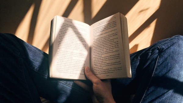 Stock photo of a person holding a book.