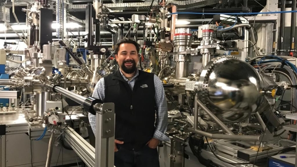 Portrait of ASU Associate Professor Gary Moore surrounded by large laboratory machinery.