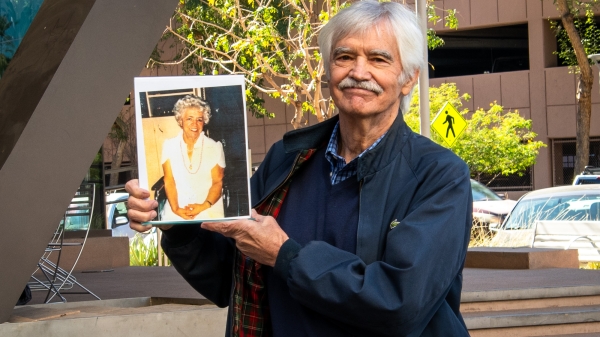 Photo of ASU Law alumnus Jim McAnally holding a photo of his mom, Virginia Miller.