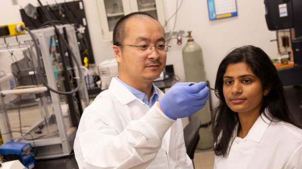 ASU Assistant Professor Kenan Song and research collaborator Mounika Kakarla wearing white coats in a lab.