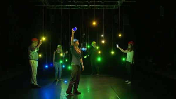Group of people under interactive light installation 
