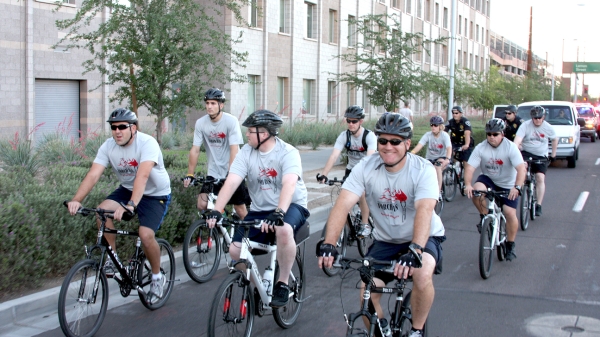 A group of ASU Police Department Officers ride their bicycles together. 