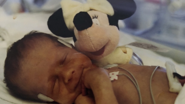Baby Taylor Zimelman next to a stuffed animal
