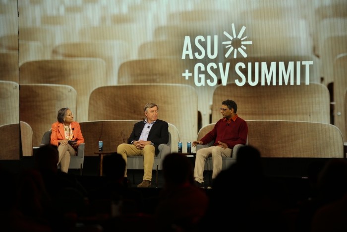 Three people sitting on stage for panel