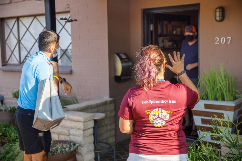 Volunteers with the Maricopa County Serosurvey greet a resident. 