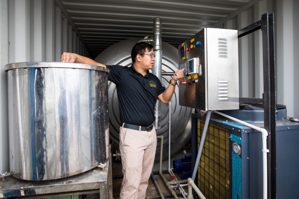  Zhihao Chen, inside the digester container, talks about the vertical farming system