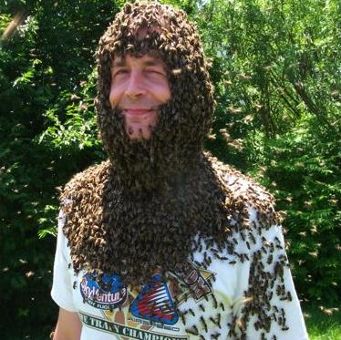 A man wears a beard made of bees