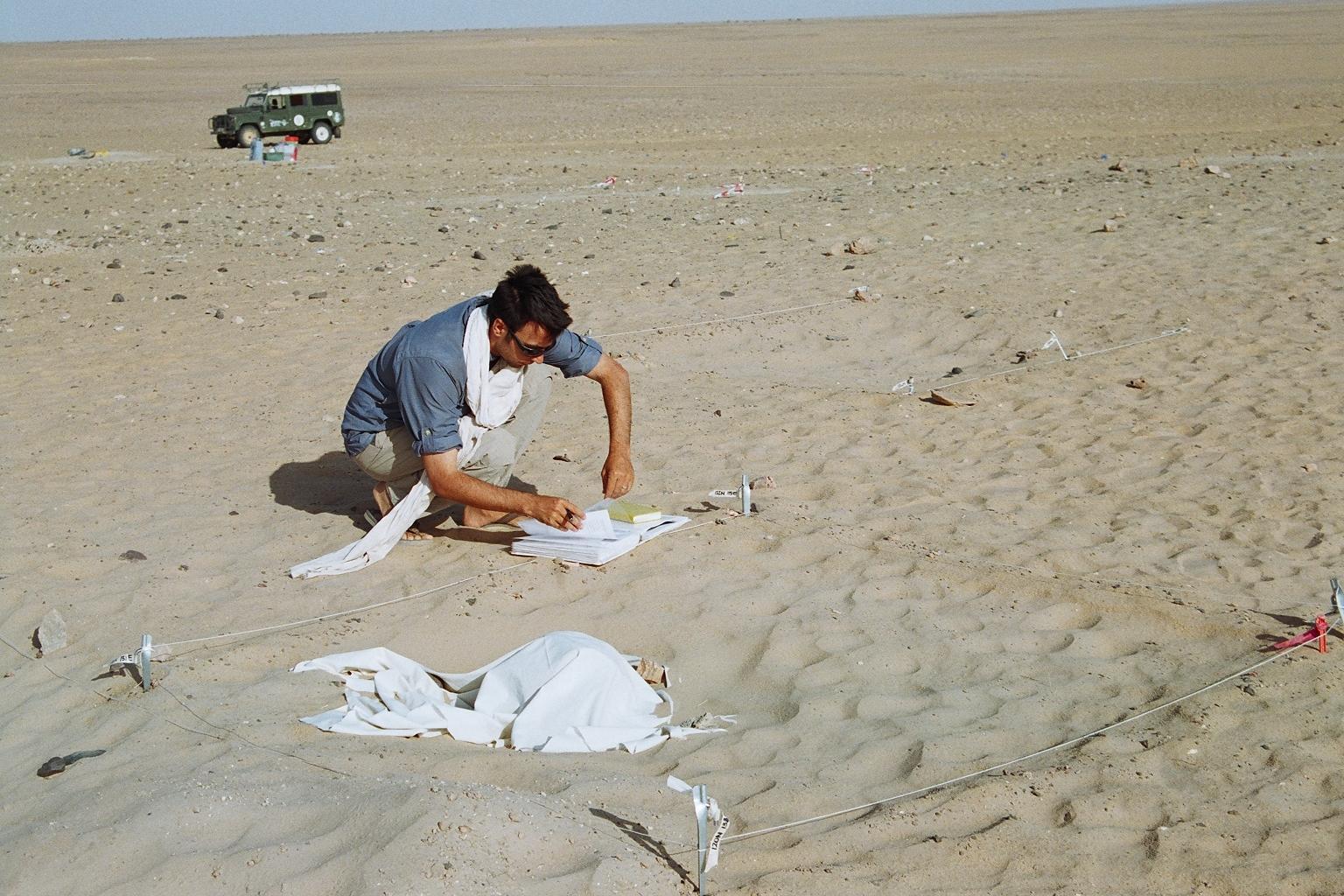 Photo of Stojanowski taking notes at his field site 