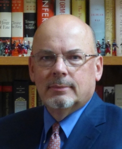 Man in glasses in front of books
